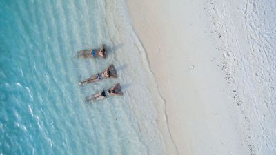 laying at beach in water