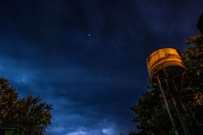 water tower in fleld at night