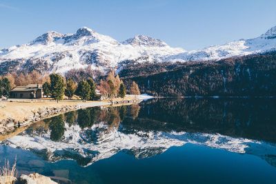 snow covered mountains near lake