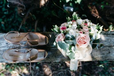 shoes and bouquet on a log