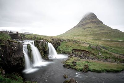 waterfalls and a cloudy mountain spire