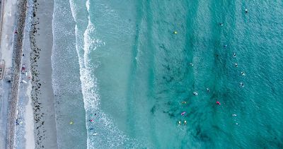 surfers in the water near beach