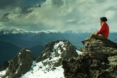 woman sitting on mountaintop