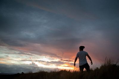 man looking at dramatic sky