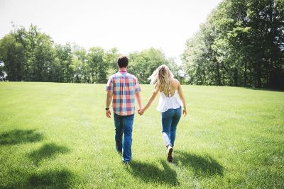 beautiful couple walking in greenery