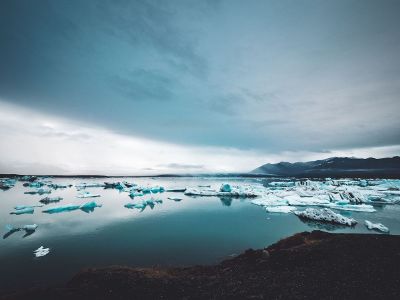 icy blue lake with mountains