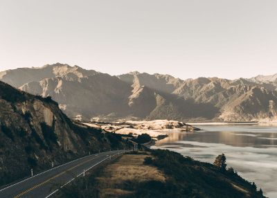 road along mountains and water