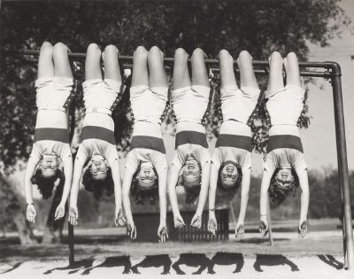 women hanging on bars