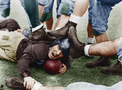 group kicking a man