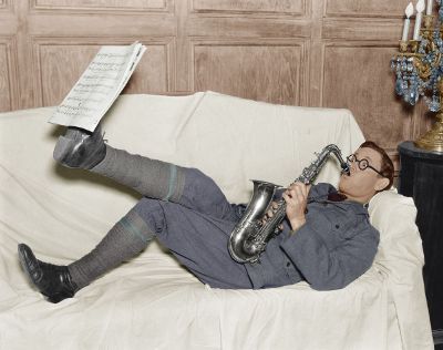 man playing saxophone on couch