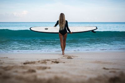 women surfing at beach