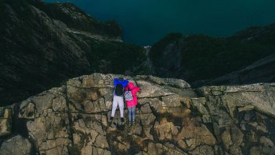 two people on rocky cliff